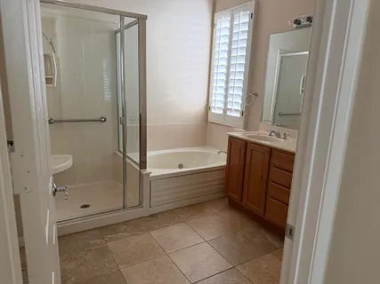 a bathroom with a bathtub and a shower