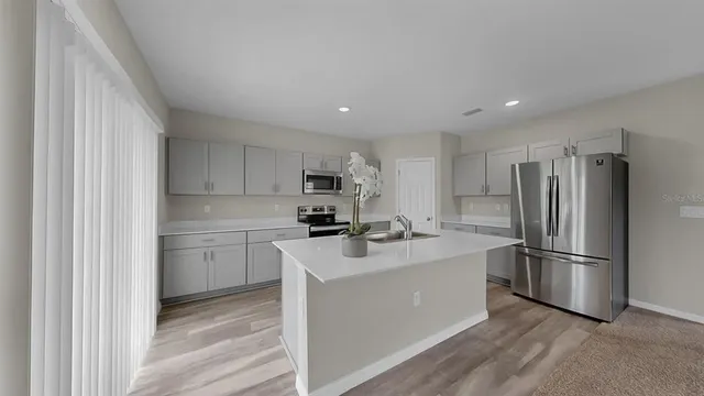 a kitchen with a sink a stove and cabinets
