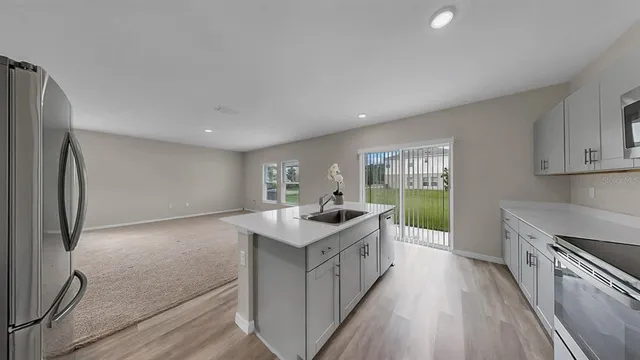 a kitchen with appliances a sink and cabinets