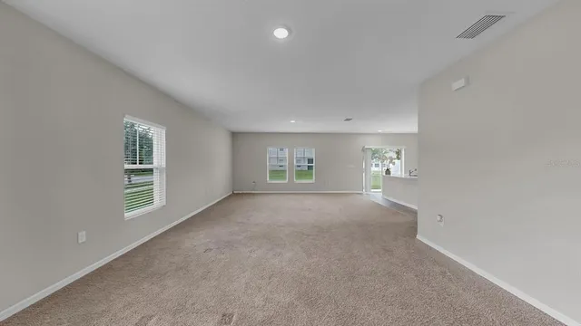a view of a big room with wooden cabinet and windows