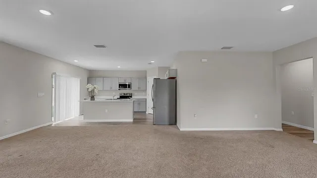 a view of a kitchen with a sink and stainless steel appliances