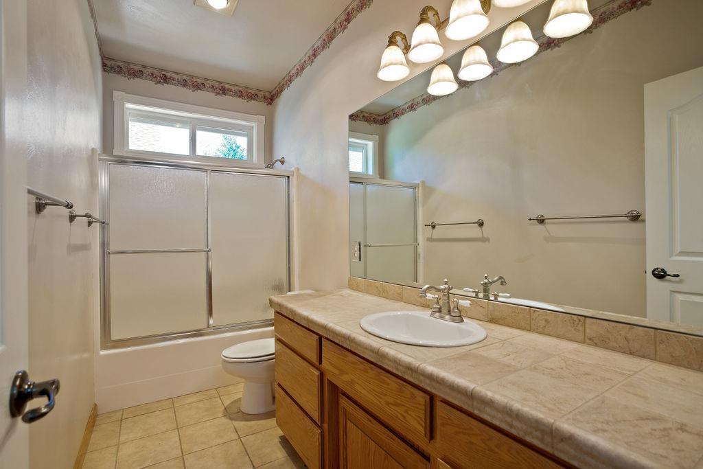 914 Ridgeview Drive Eagle Point, OR 97524 - Photo 32 of 34 a bathroom with a granite countertop sink mirror vanity and toilet