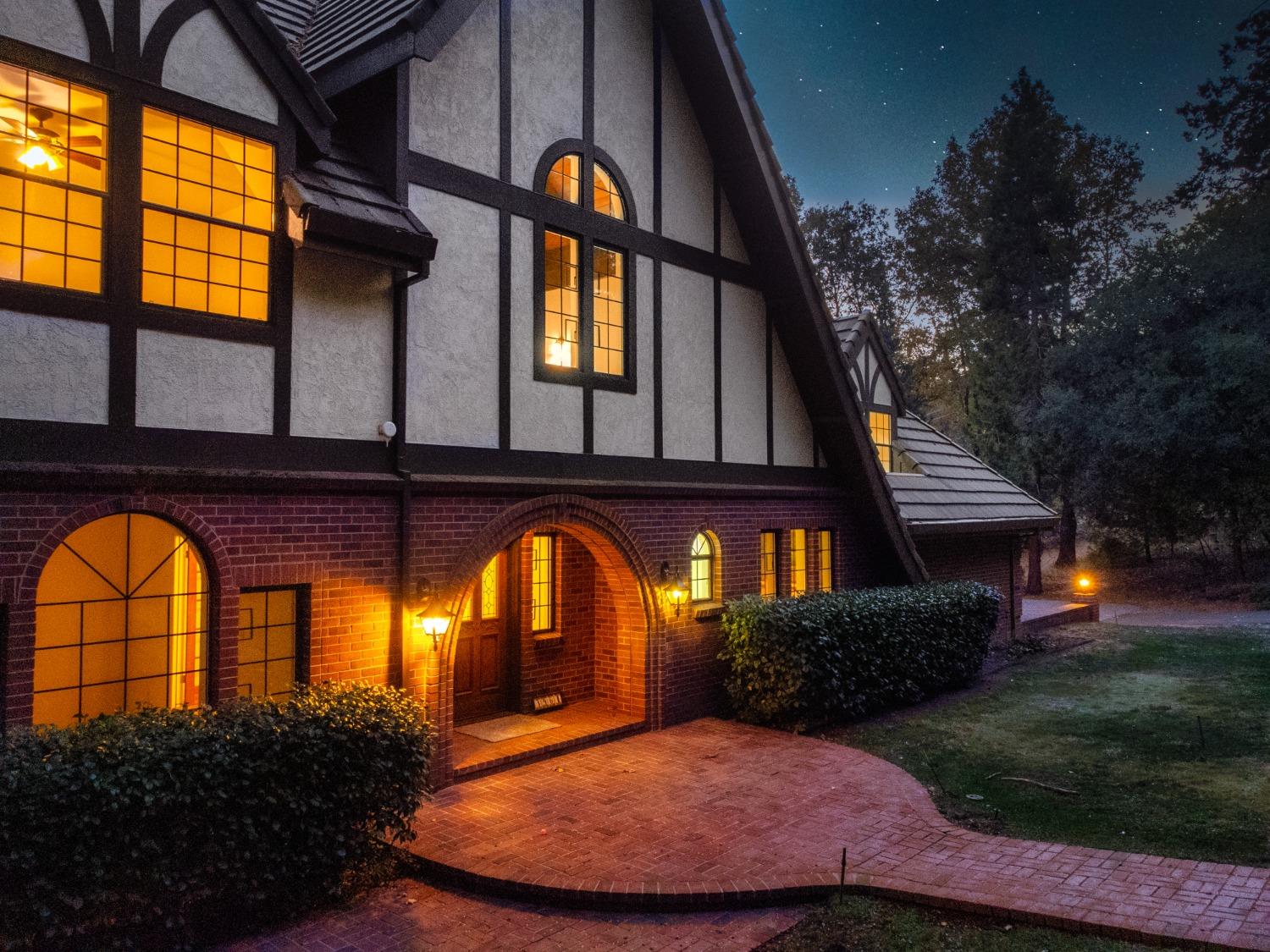 3961 7 Ridges Road Camino, CA 95709 - Photo 12 of 86 a view of a brick house with a large windows and a small yard