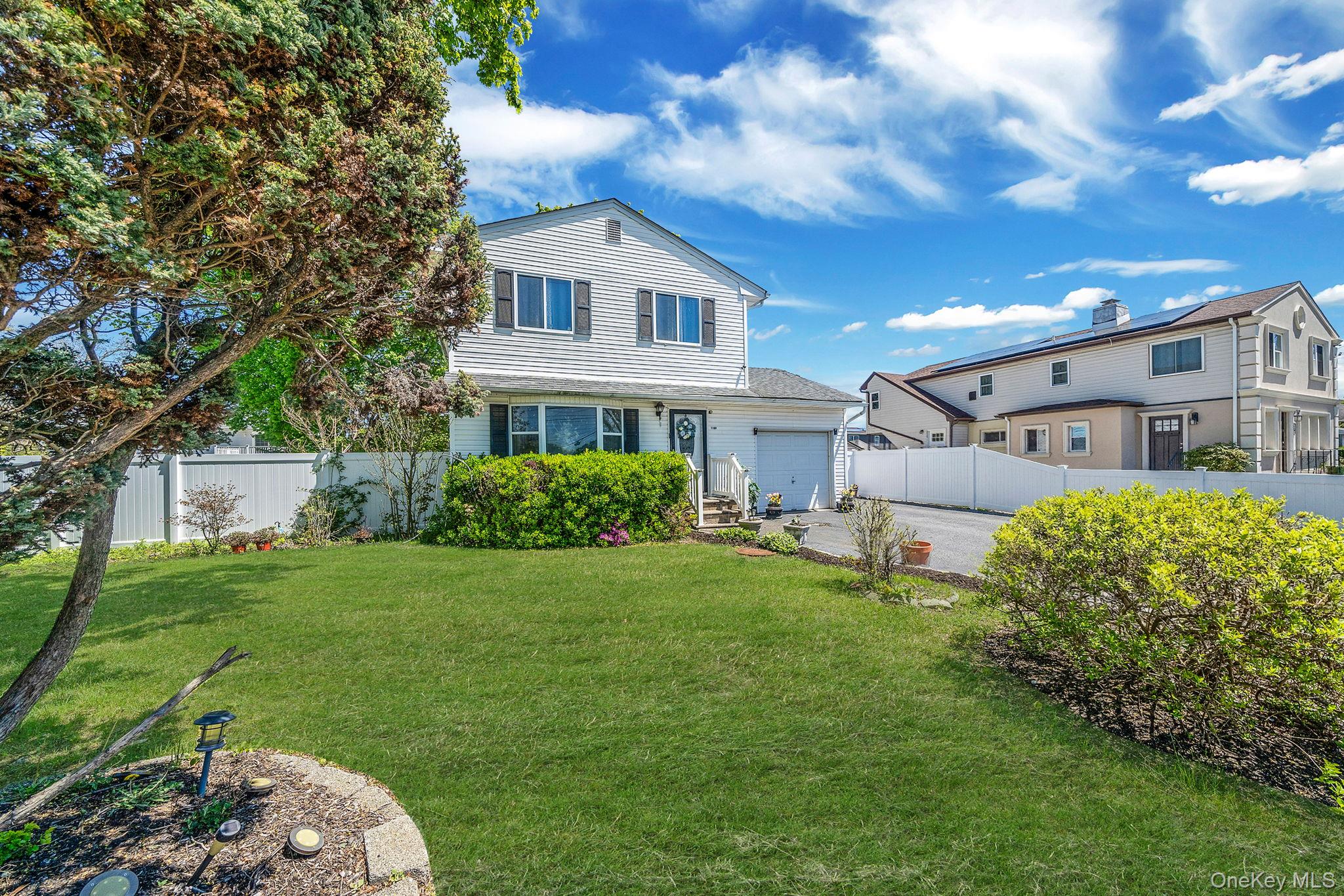 1169 Little E Neck Road West Babylon, NY 11704 - Photo 2 of 28 a house view with a garden space