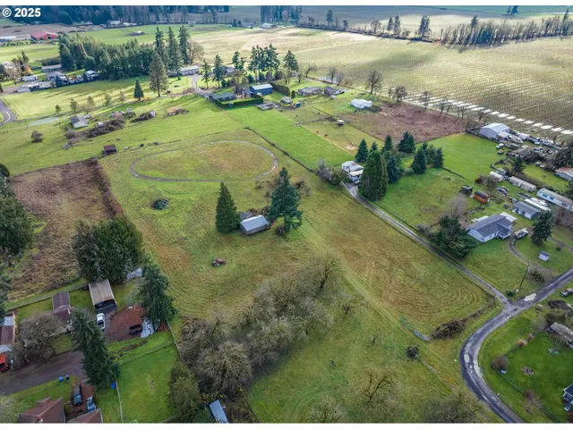 an aerial view of a residential houses with outdoor space