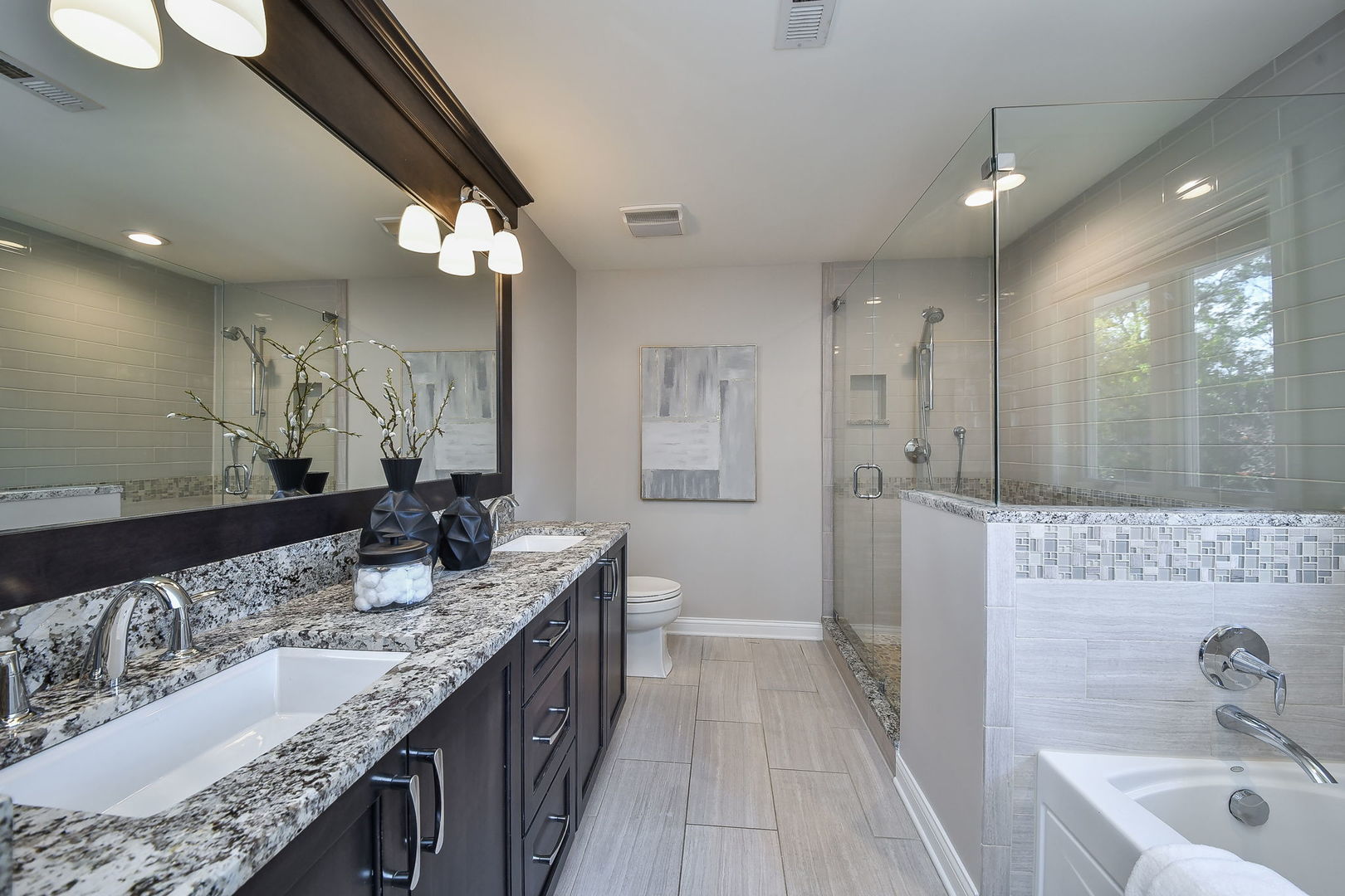 4733 Roslyn Road Downers Grove, IL 60515 - Photo 18 of 46 a bathroom with a granite countertop double vanity sink a mirror and shower