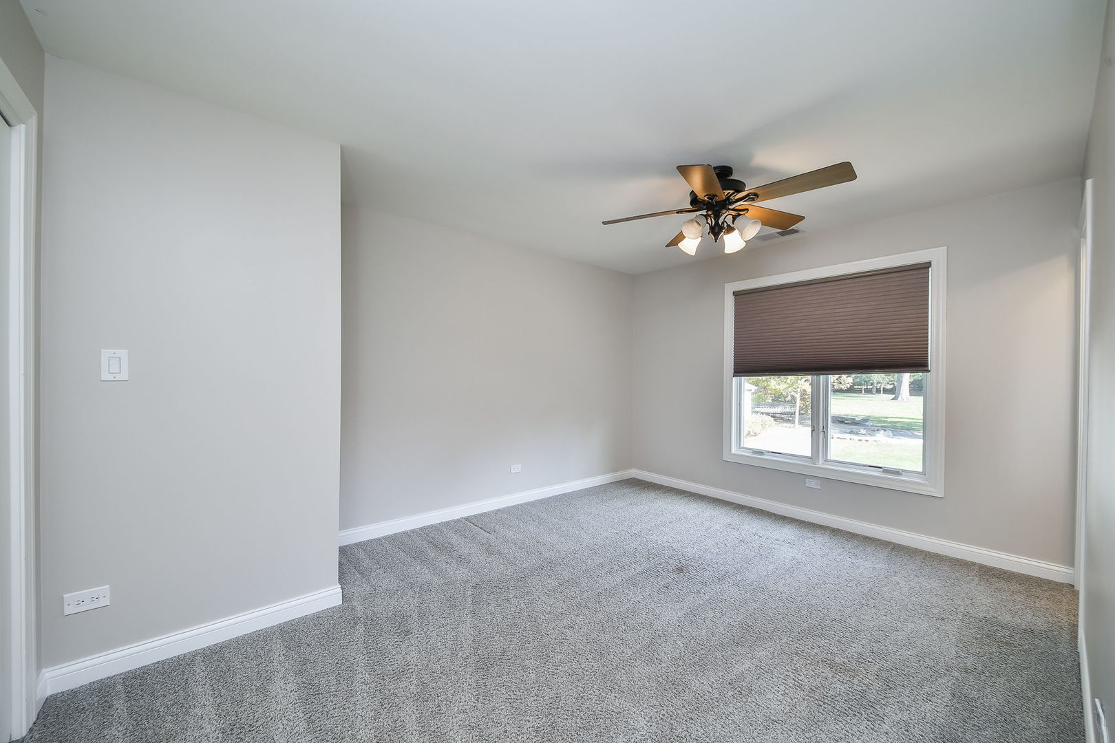 4733 Roslyn Road Downers Grove, IL 60515 - Photo 22 of 46 an empty room with windows and ceiling fan
