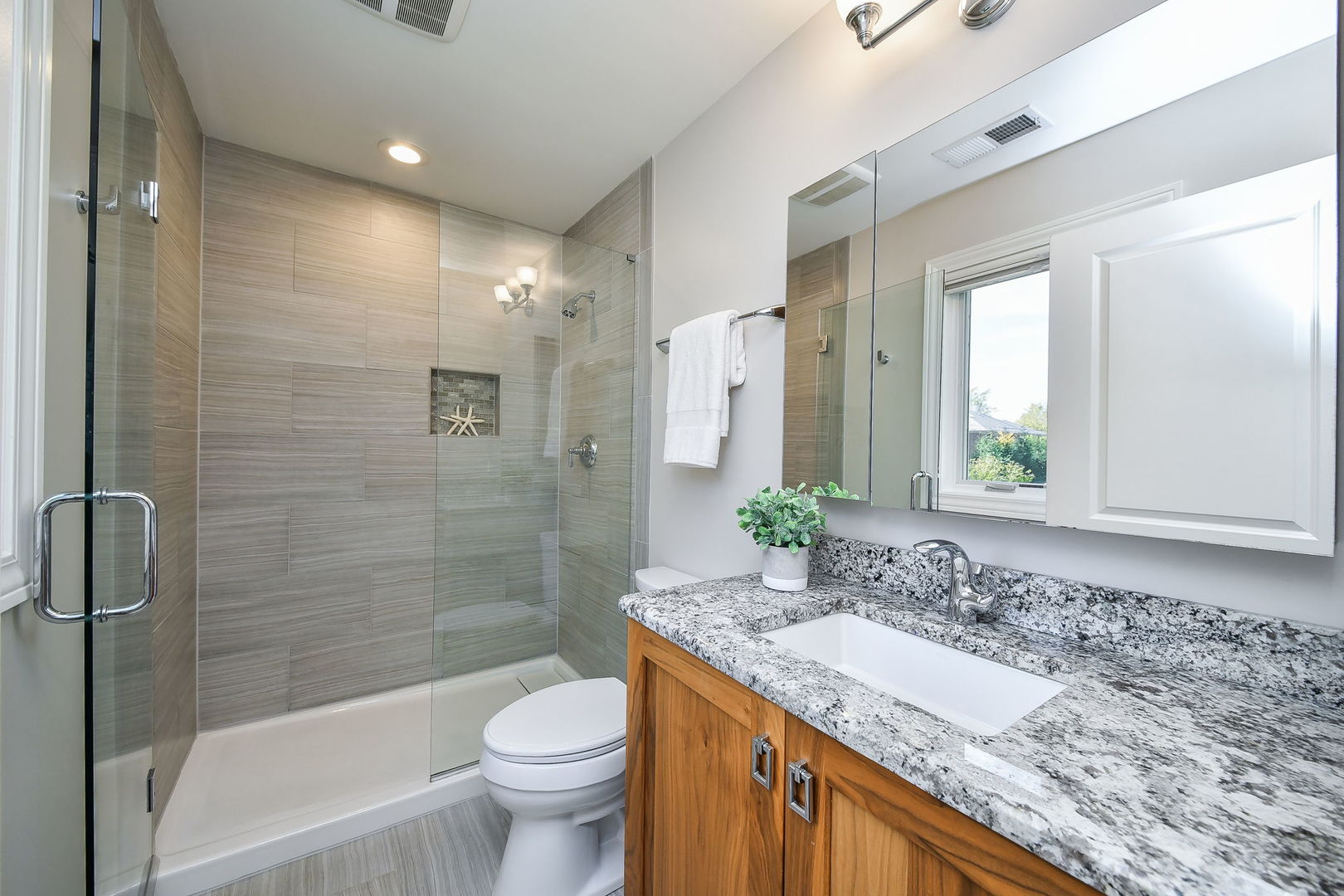 4733 Roslyn Road Downers Grove, IL 60515 - Photo 23 of 46 a bathroom with a granite countertop sink a toilet and shower