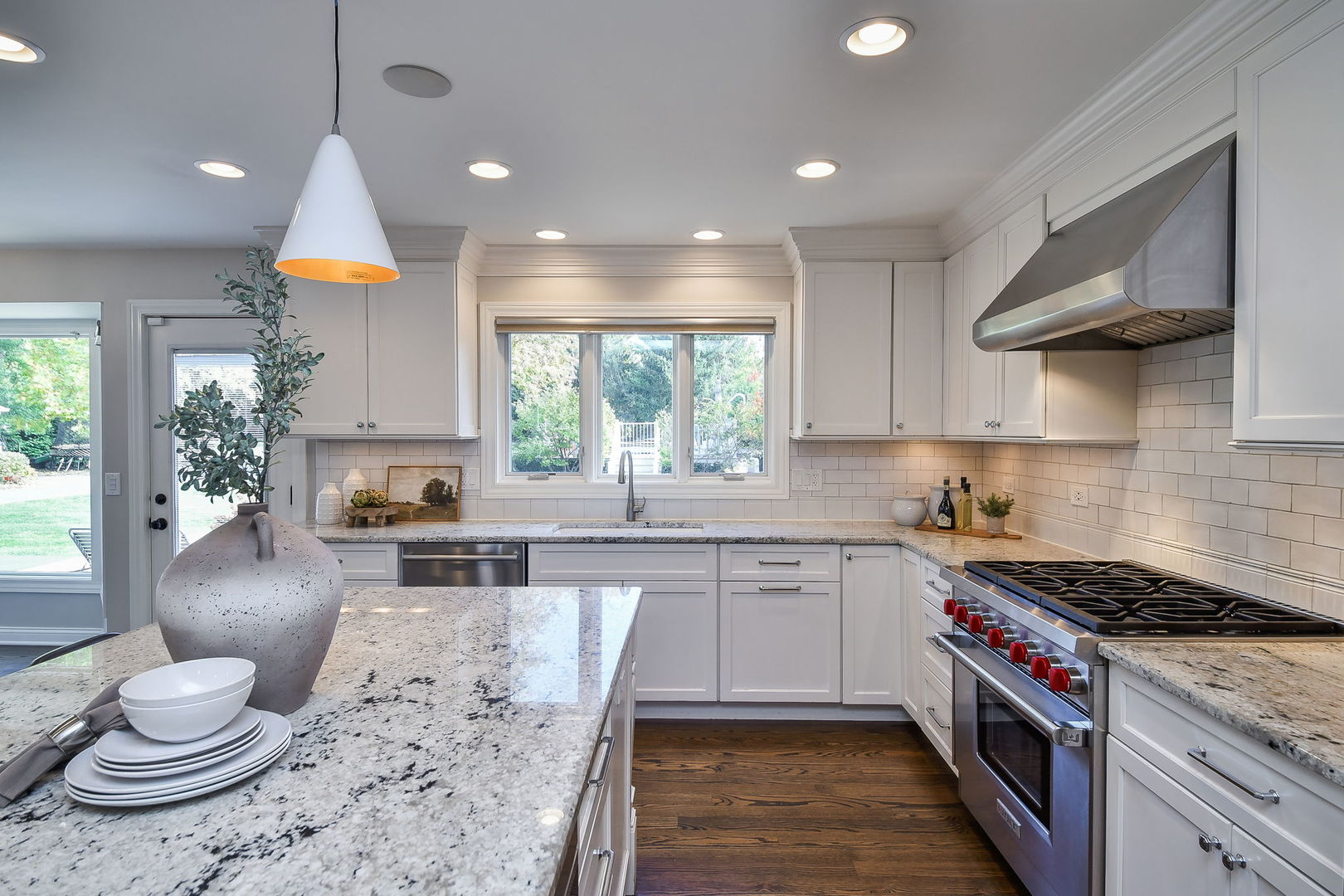 4733 Roslyn Road Downers Grove, IL 60515 - Photo 9 of 46 a kitchen with a stove a sink a kitchen island with wooden cabinets and floor