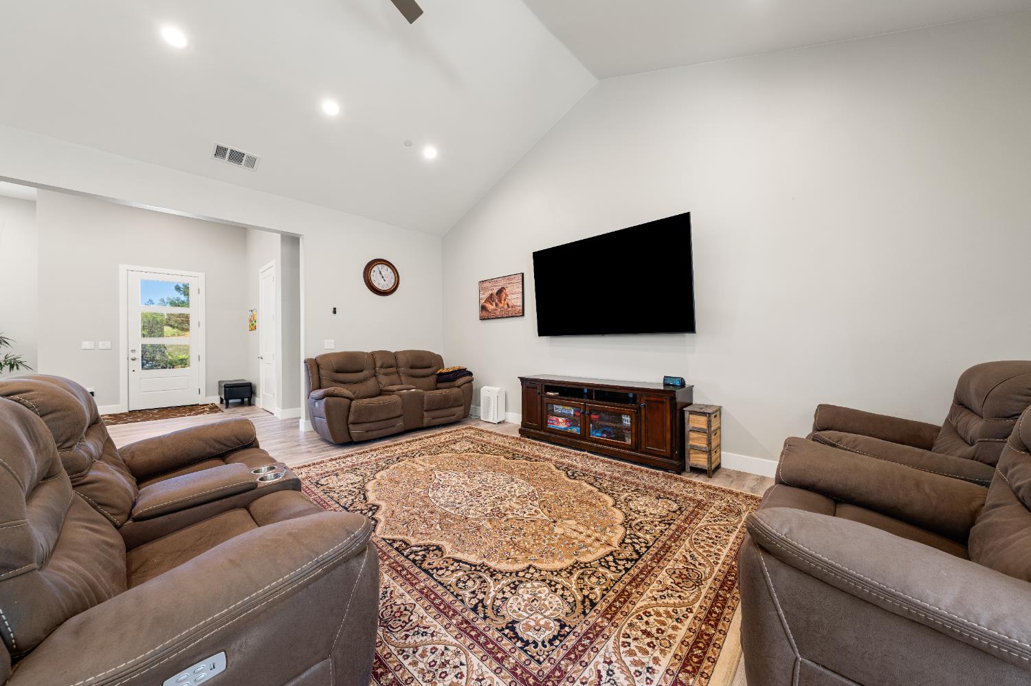 3629 Chelsea Road Cameron Park, CA 95682 - Photo 11 of 44 a living room with furniture a fireplace and a flat screen tv
