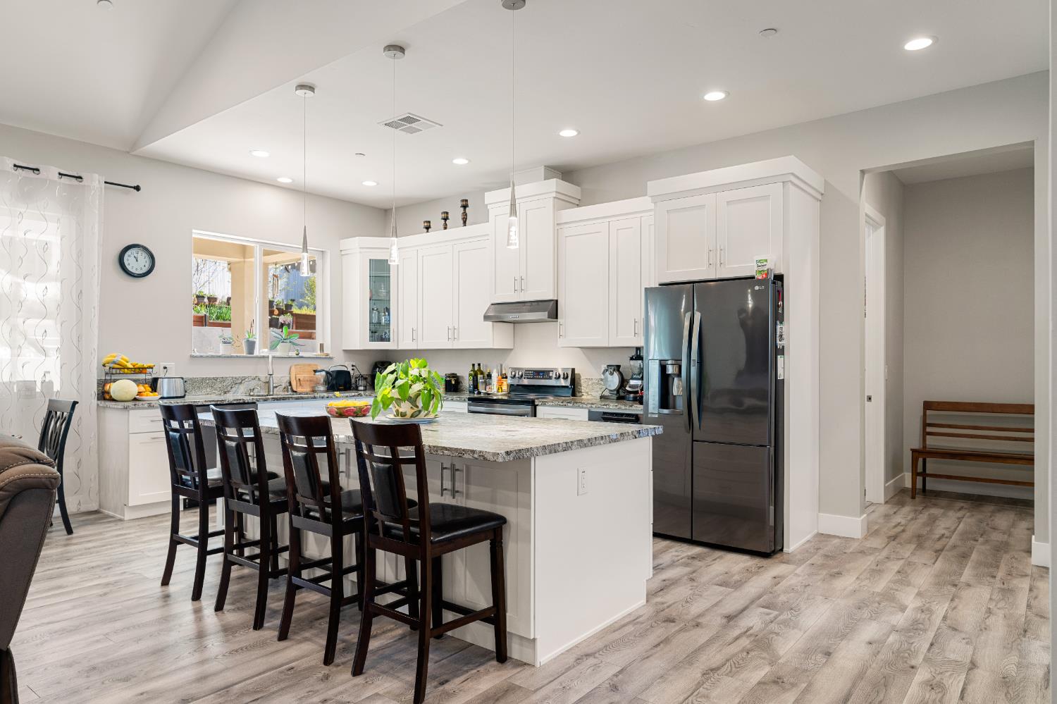3629 Chelsea Road Cameron Park, CA 95682 - Photo 12 of 44 a kitchen with stainless steel appliances a dining table chairs refrigerator and cabinets
