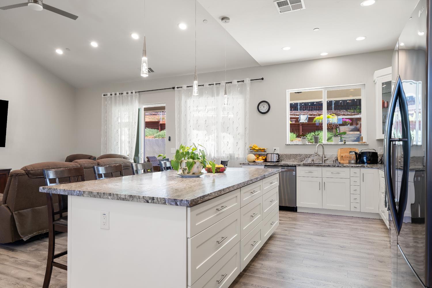3629 Chelsea Road Cameron Park, CA 95682 - Photo 14 of 44 a kitchen with kitchen island granite countertop a sink stove and refrigerator