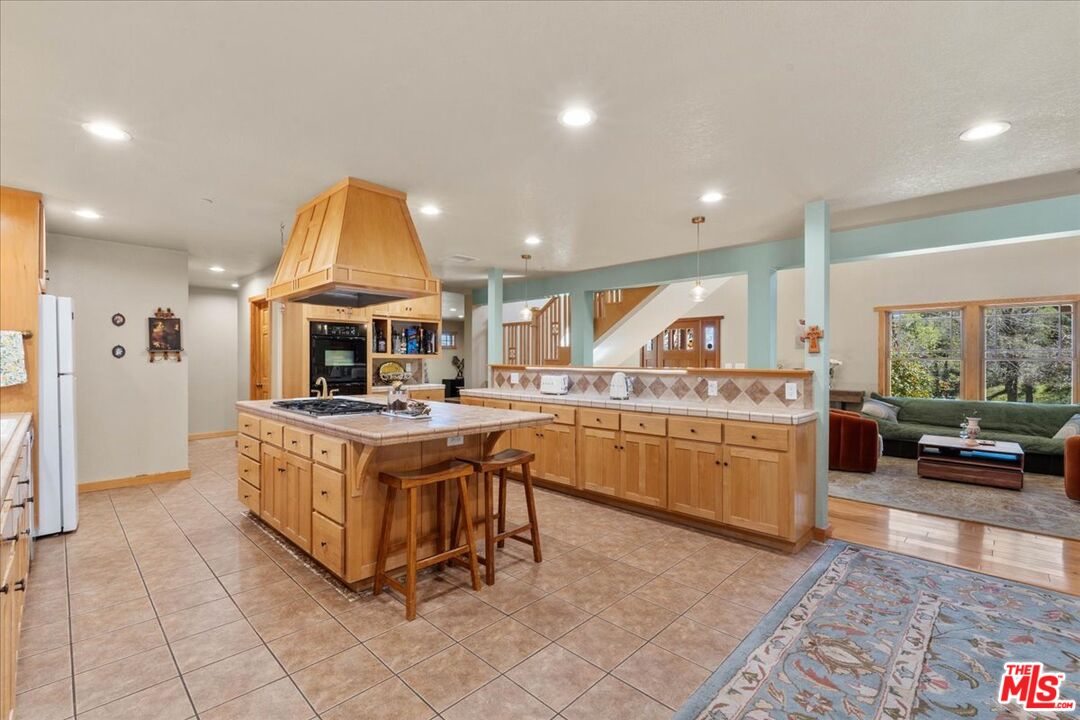 28200 Pine Canyon Road Lake Hughes, CA 93532 - Photo 11 of 52 a kitchen with stainless steel appliances granite countertop a stove and a sink