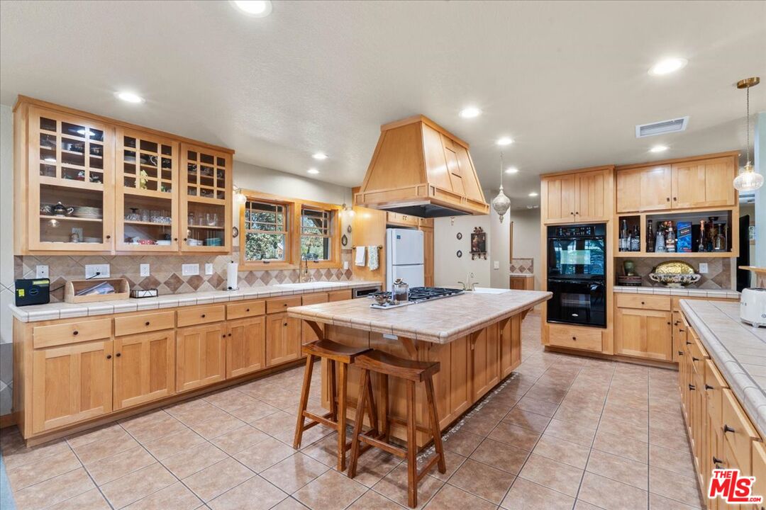 28200 Pine Canyon Road Lake Hughes, CA 93532 - Photo 12 of 52 a kitchen with stainless steel appliances granite countertop a stove and a sink