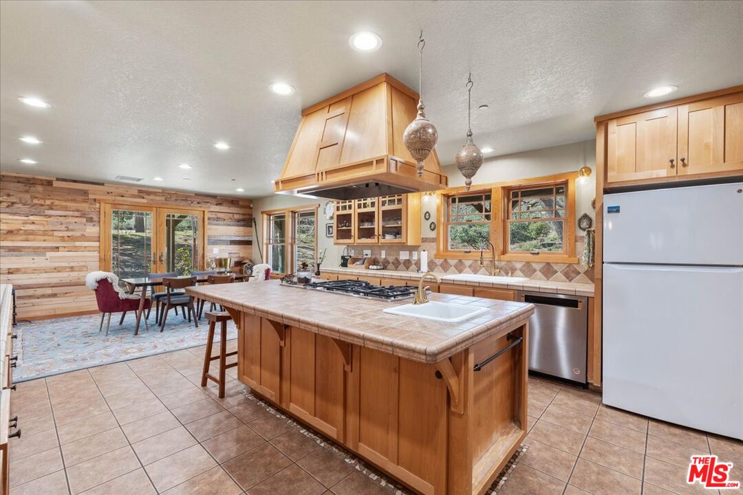 28200 Pine Canyon Road Lake Hughes, CA 93532 - Photo 13 of 52 a kitchen with stainless steel appliances granite countertop a stove and a refrigerator