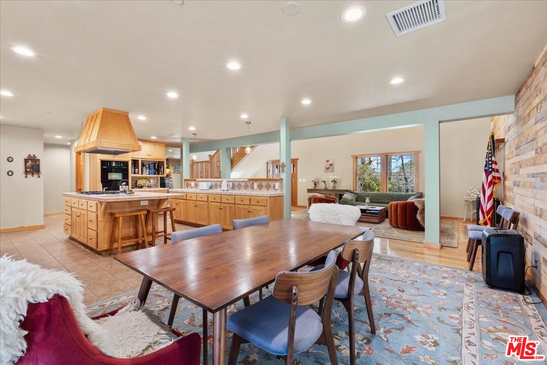 28200 Pine Canyon Road Lake Hughes, CA 93532 - Photo 16 of 52 a kitchen with stainless steel appliances kitchen island granite countertop a dining table chairs and view living room