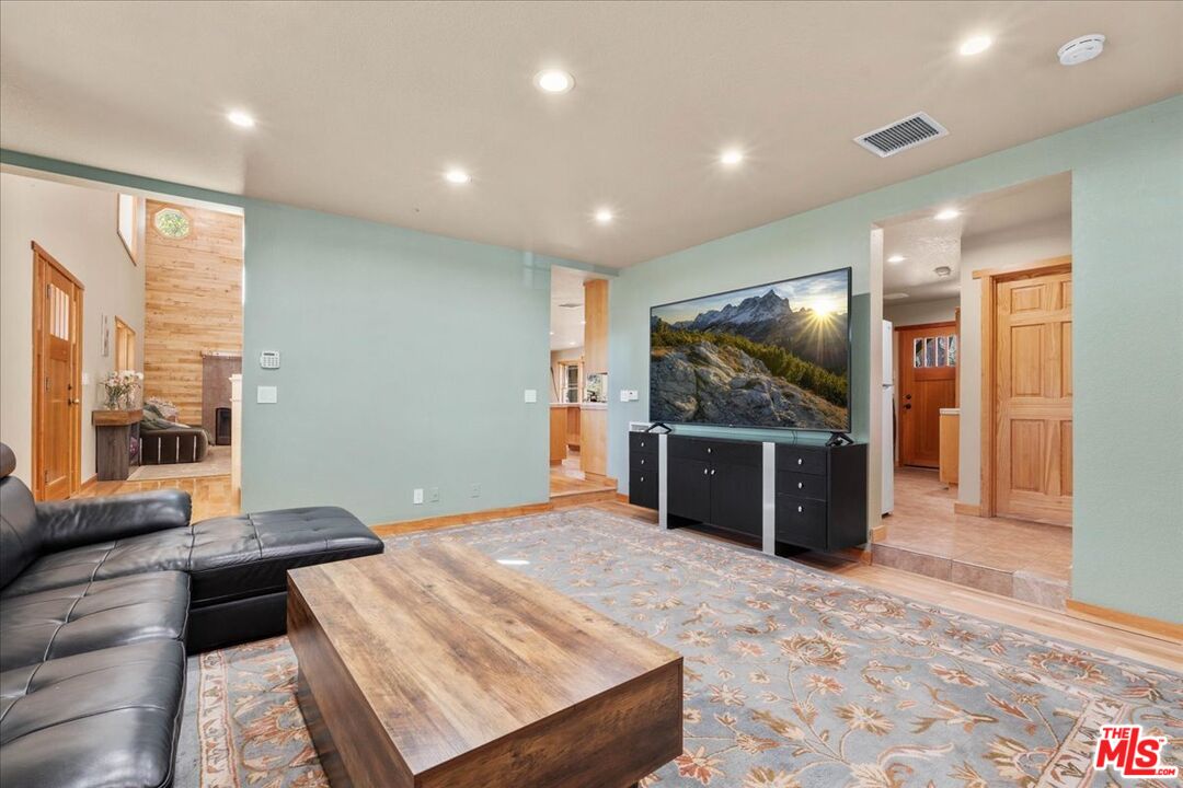 28200 Pine Canyon Road Lake Hughes, CA 93532 - Photo 19 of 52 a living room with furniture and a flat screen tv