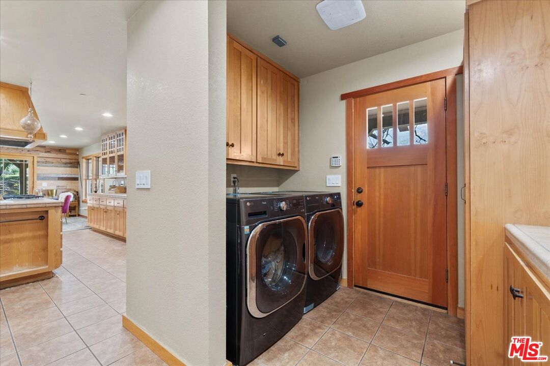28200 Pine Canyon Road Lake Hughes, CA 93532 - Photo 21 of 52 a view of a hallway with washer and dryer