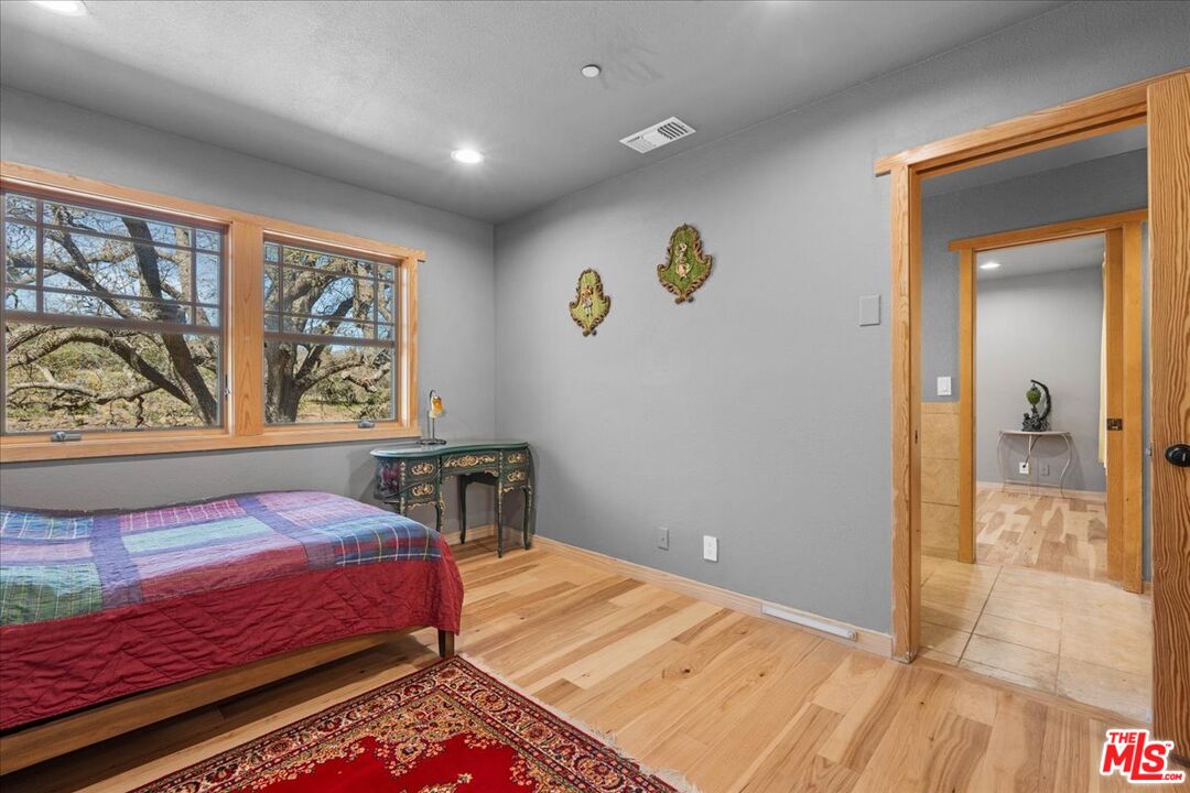 28200 Pine Canyon Road Lake Hughes, CA 93532 - Photo 23 of 52 a bedroom with a bed and a window