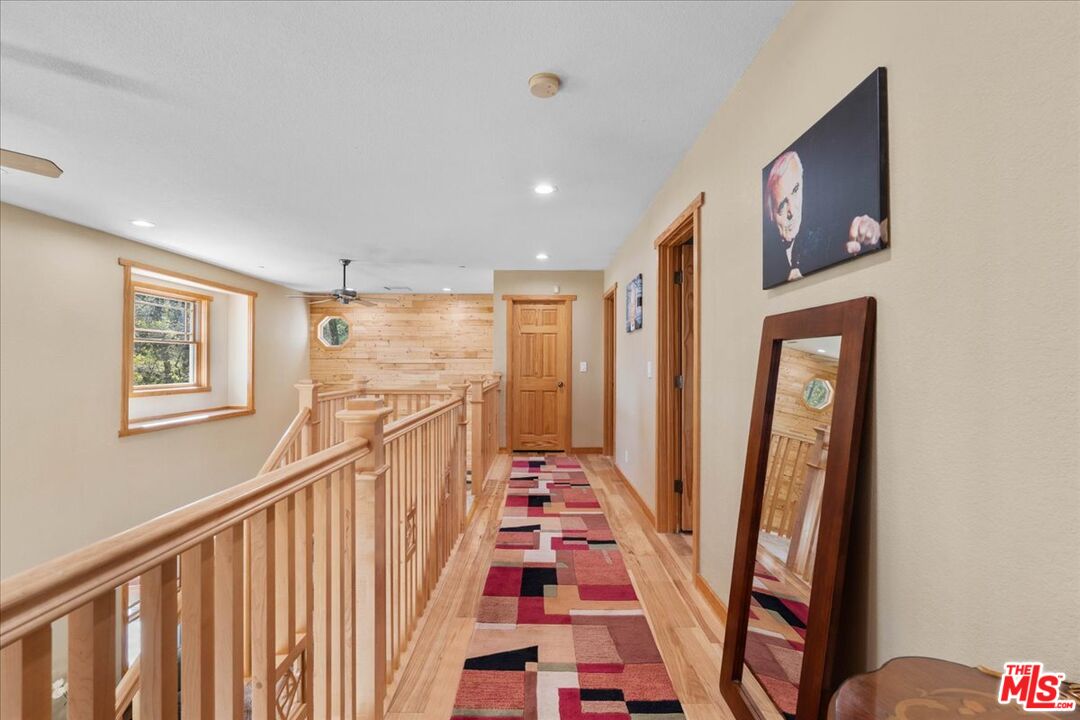 28200 Pine Canyon Road Lake Hughes, CA 93532 - Photo 28 of 52 a view of a hallway with wooden floor and stairs