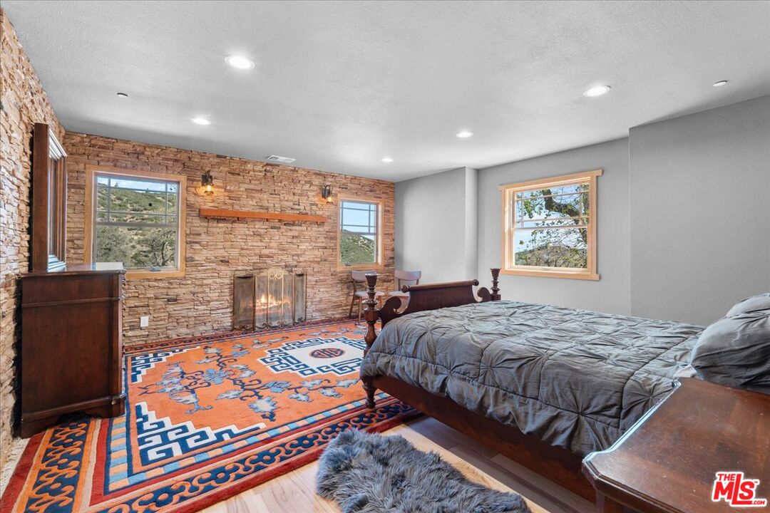 28200 Pine Canyon Road Lake Hughes, CA 93532 - Photo 29 of 52 a bed room with a bed and a couch