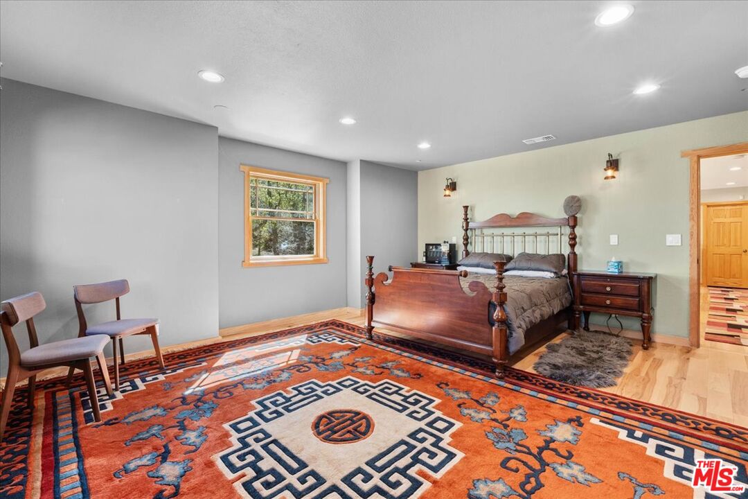 28200 Pine Canyon Road Lake Hughes, CA 93532 - Photo 30 of 52 a bedroom with a bed and a chair