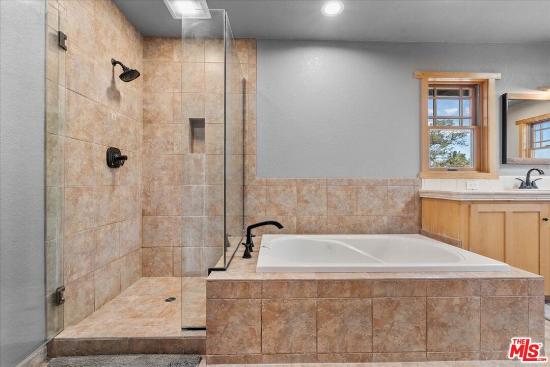 28200 Pine Canyon Road Lake Hughes, CA 93532 - Photo 36 of 52 a bathroom with a sink a mirror and a bathtub