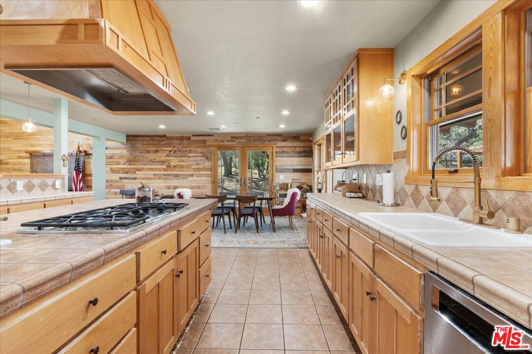 28200 Pine Canyon Road Lake Hughes, CA 93532 - Photo 10 of 52 a kitchen with stainless steel appliances granite countertop a stove a sink and a refrigerator