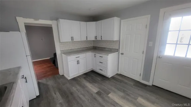 a view of cabinets and wooden floor