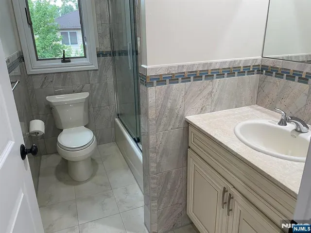 a bathroom with a sink toilet and tub