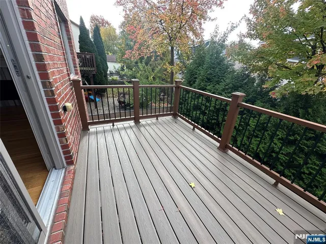 a view of balcony with wooden floor and fence