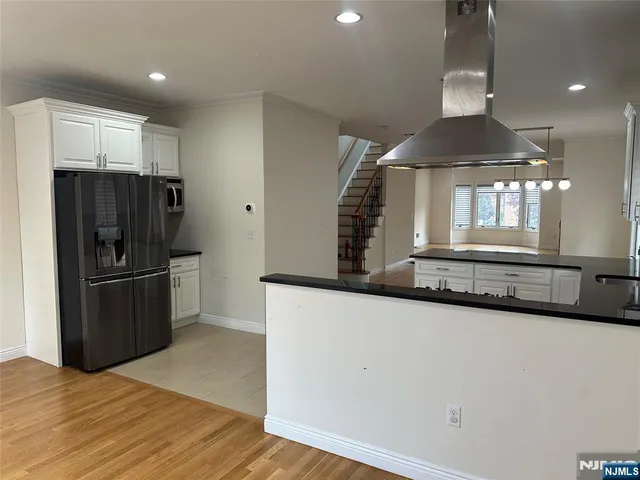a kitchen with stainless steel appliances a refrigerator and a stove top oven