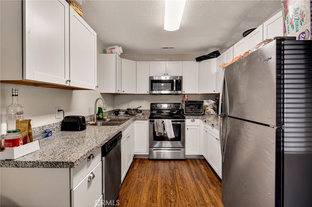 703 West 2nd Avenue Chico, CA 95926 - Photo 14 of 27 a kitchen with a refrigerator sink and microwave