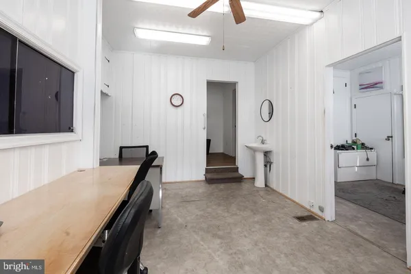 a view of a utility room with wooden floor