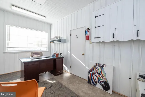 a kitchen with a refrigerator and white cabinets
