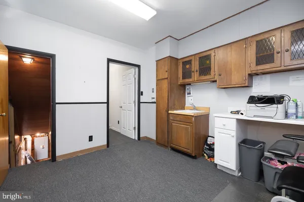 a bathroom with a granite countertop toilet and a sink