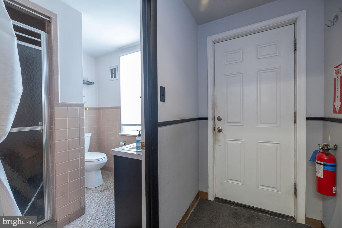 1017 Market Street Gloucester City, NJ 08030 - Photo 20 of 40 a bathroom with a granite countertop toilet and a sink
