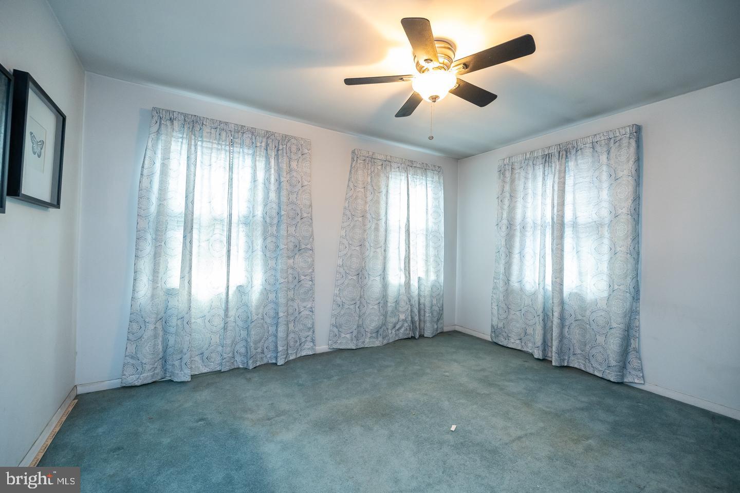 1017 Market Street Gloucester City, NJ 08030 - Photo 23 of 40 a view of an empty room with chandelier fan and windows