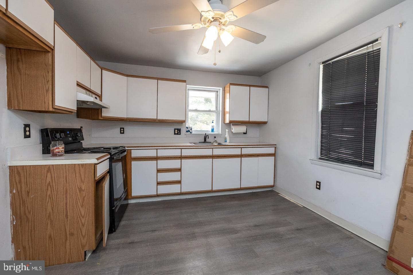 1017 Market Street Gloucester City, NJ 08030 - Photo 25 of 40 a kitchen with stainless steel appliances sink cabinets and window