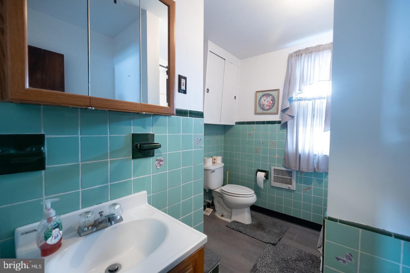 1017 Market Street Gloucester City, NJ 08030 - Photo 26 of 40 a bathroom with a sink toilet and shower