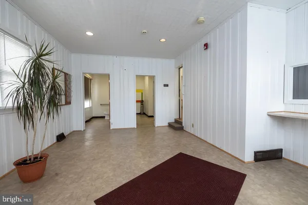 a view of a hallway with a couch and a window