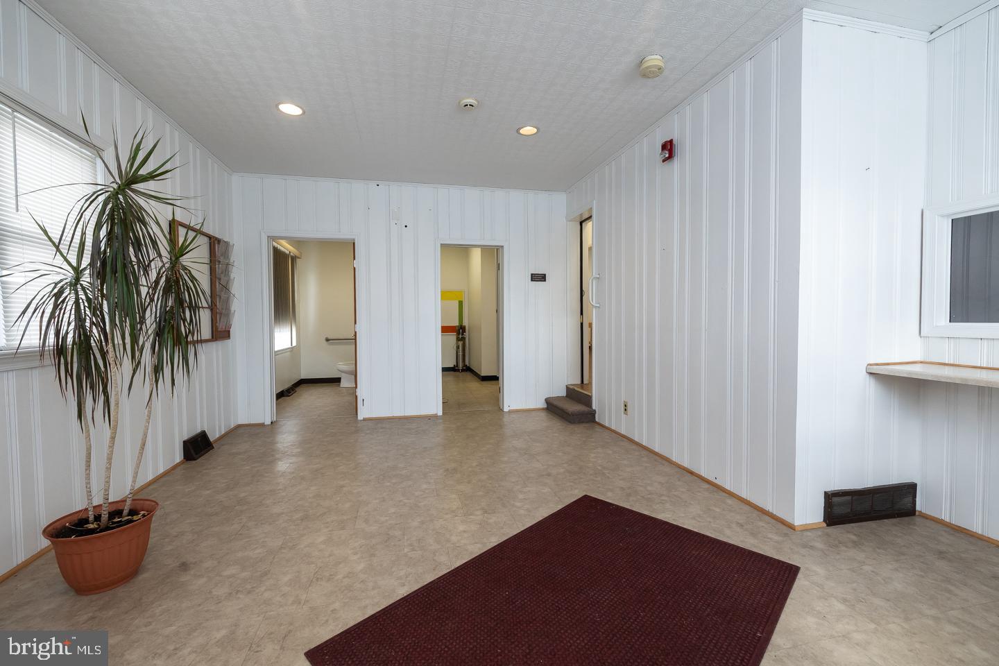 1017 Market Street Gloucester City, NJ 08030 - Photo 3 of 40 a view of a hallway with a couch and a window
