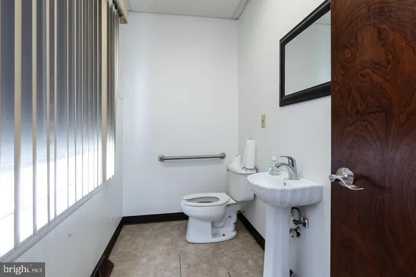 a bathroom with a toilet sink and mirror