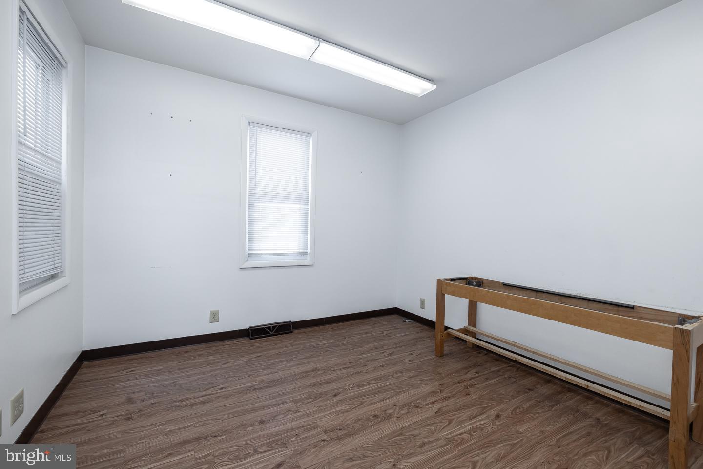 1017 Market Street Gloucester City, NJ 08030 - Photo 7 of 40 a view of an empty room with wooden floor and a window