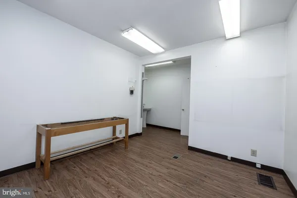 a view of a room with wooden floor and bench