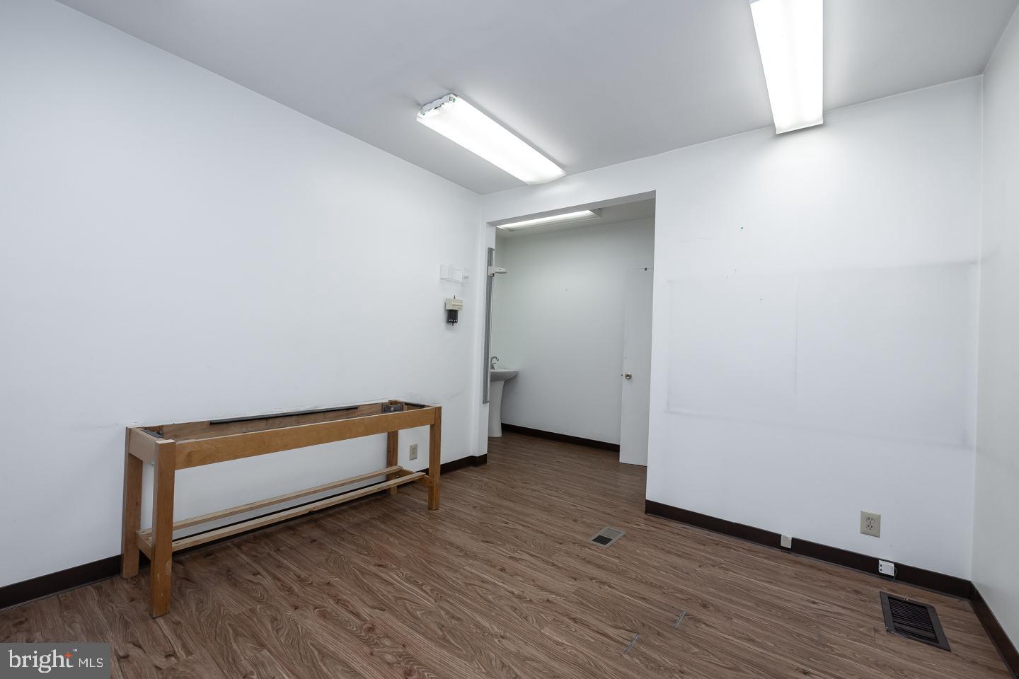 1017 Market Street Gloucester City, NJ 08030 - Photo 8 of 40 a view of a room with wooden floor and bench