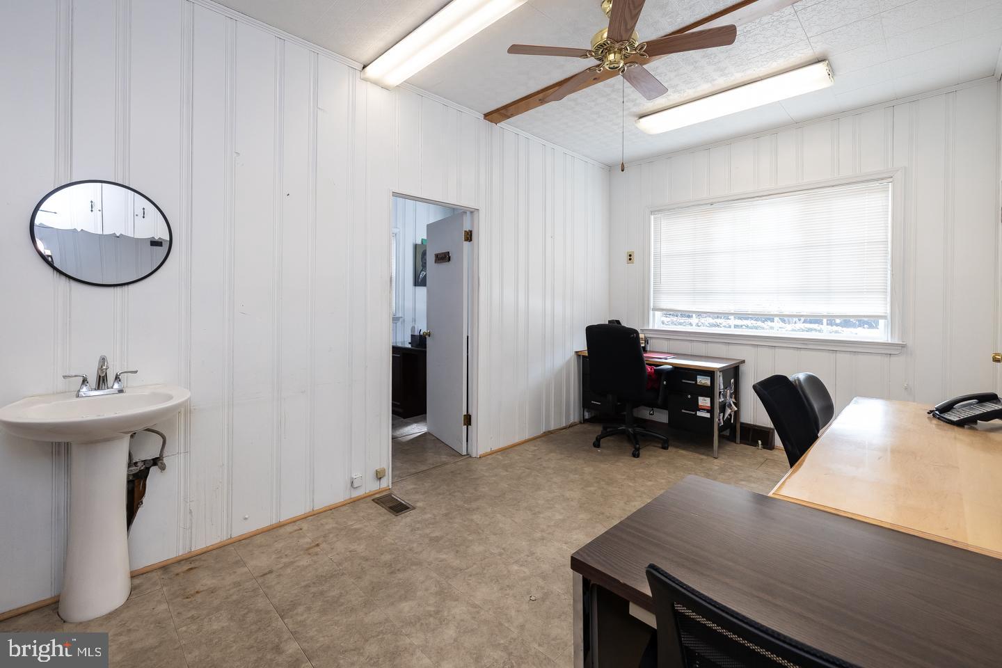 1017 Market Street Gloucester City, NJ 08030 - Photo 10 of 40 a view of a workspace with furniture and a window