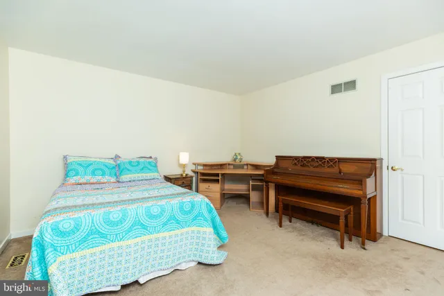 a bedroom with a bed and a piano