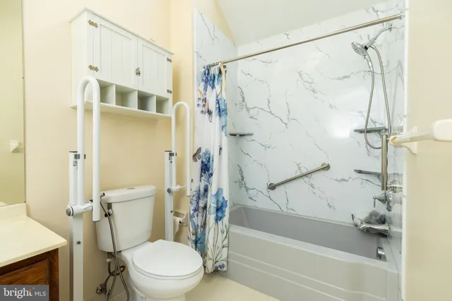 a bathroom with a toilet and shower