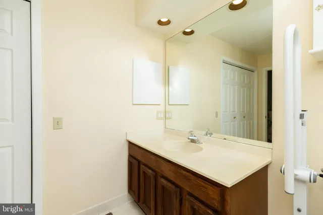 a bathroom with a sink vanity and a mirror